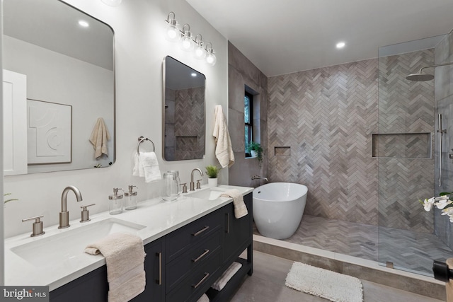 bathroom with shower with separate bathtub, vanity, and tile walls