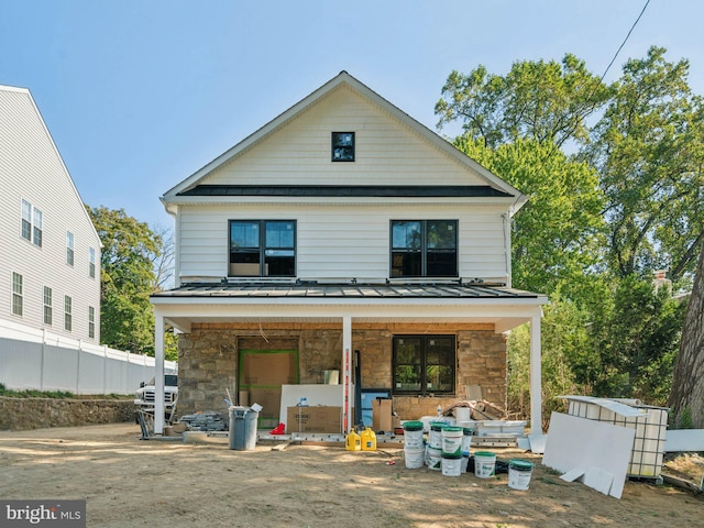 back of property with a porch