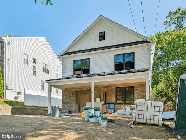 back of property with covered porch