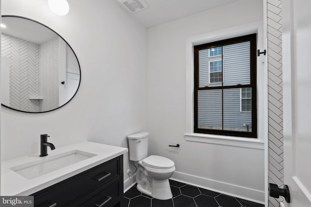 bathroom featuring tile patterned floors, vanity, and toilet