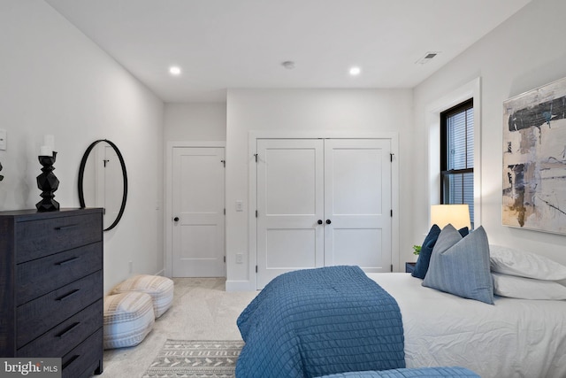 carpeted bedroom with a closet