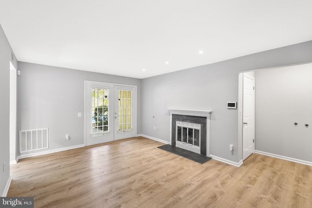 unfurnished living room with light hardwood / wood-style flooring