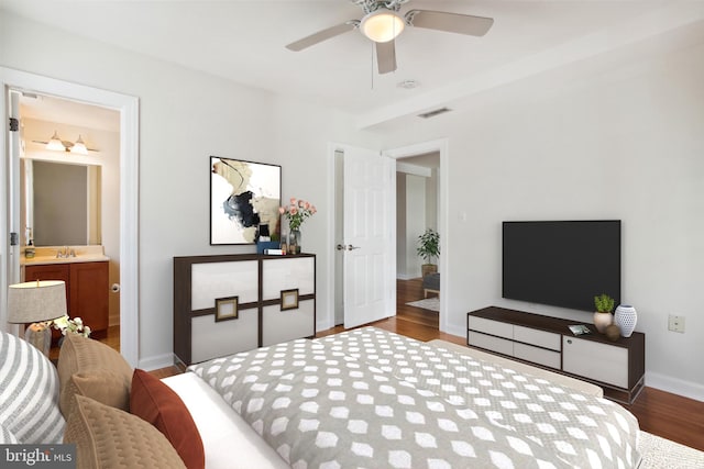 bedroom featuring wood-type flooring, ceiling fan, sink, and connected bathroom