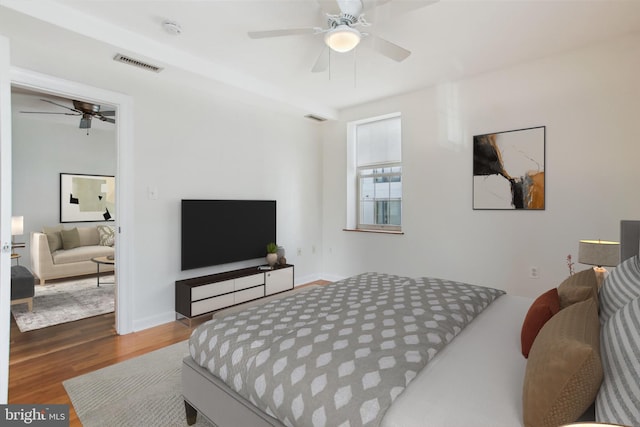 bedroom featuring hardwood / wood-style flooring and ceiling fan