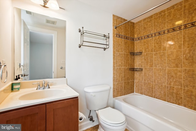 full bathroom with vanity, toilet, and tiled shower / bath combo