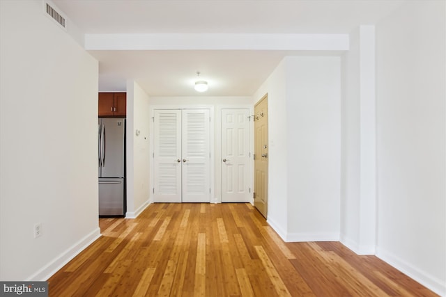 corridor with light hardwood / wood-style flooring