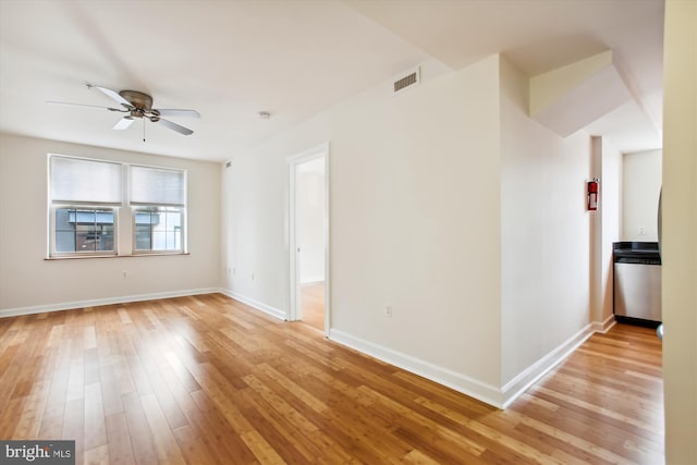 spare room with light hardwood / wood-style floors and ceiling fan