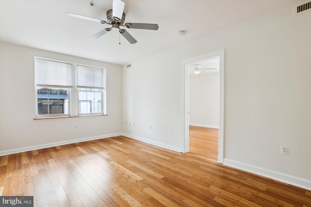 empty room featuring ceiling fan and light hardwood / wood-style flooring