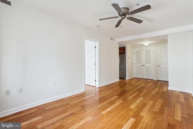 spare room with hardwood / wood-style floors and ceiling fan