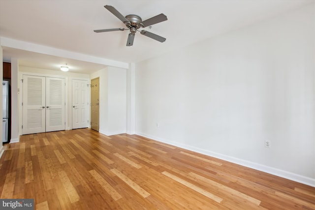 unfurnished living room featuring hardwood / wood-style floors and ceiling fan