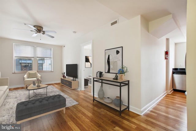 living room featuring light hardwood / wood-style floors and ceiling fan