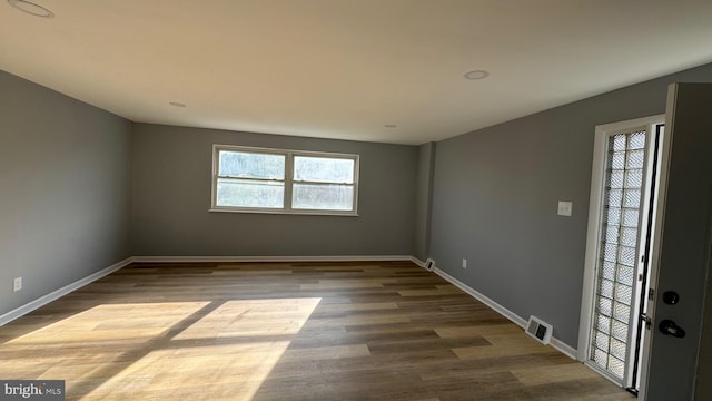 unfurnished room featuring hardwood / wood-style floors