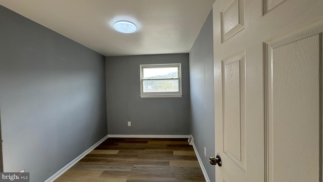 empty room with dark wood-type flooring