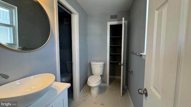 bathroom featuring vanity and toilet