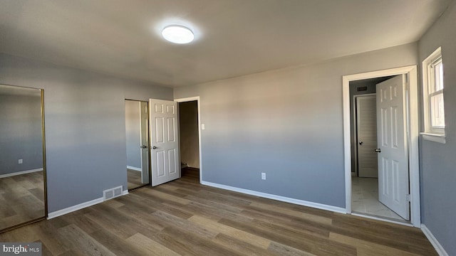 unfurnished bedroom featuring hardwood / wood-style flooring