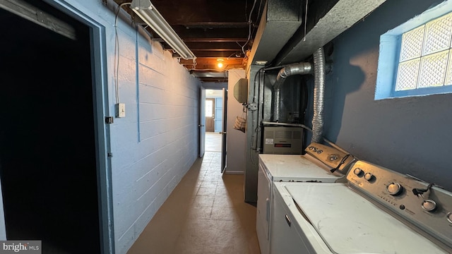 laundry area with heating unit and washing machine and clothes dryer