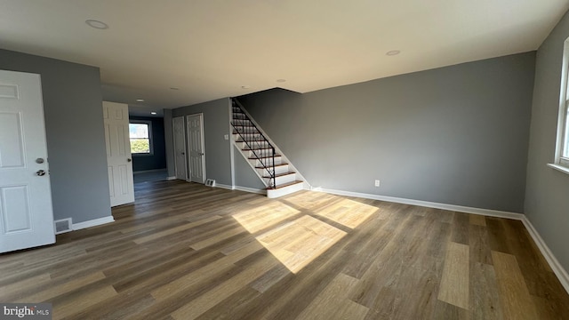 unfurnished living room featuring hardwood / wood-style flooring