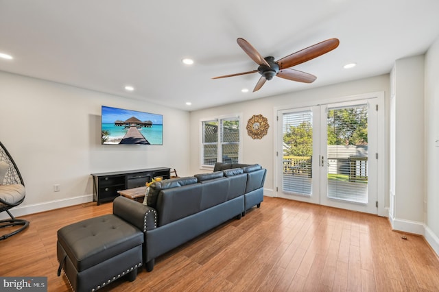 living room featuring hardwood / wood-style floors, french doors, and ceiling fan