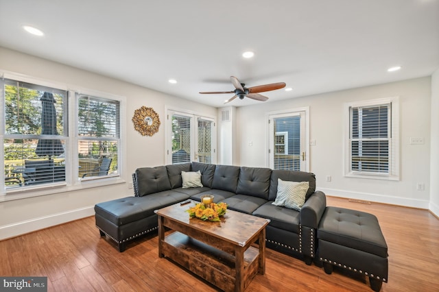 living room featuring hardwood / wood-style flooring and ceiling fan