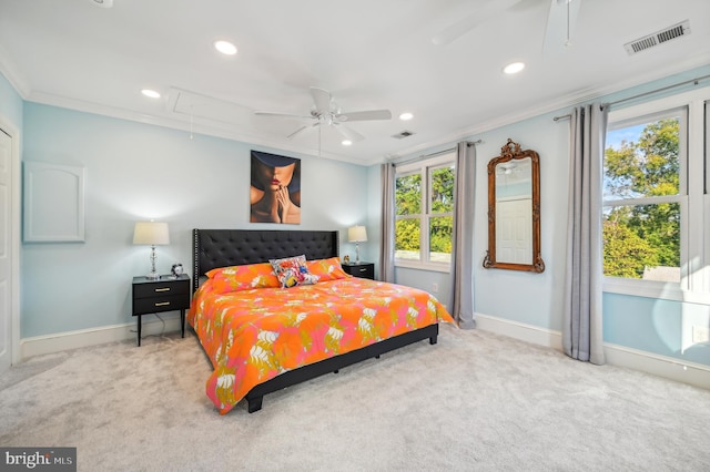 carpeted bedroom featuring ceiling fan and crown molding