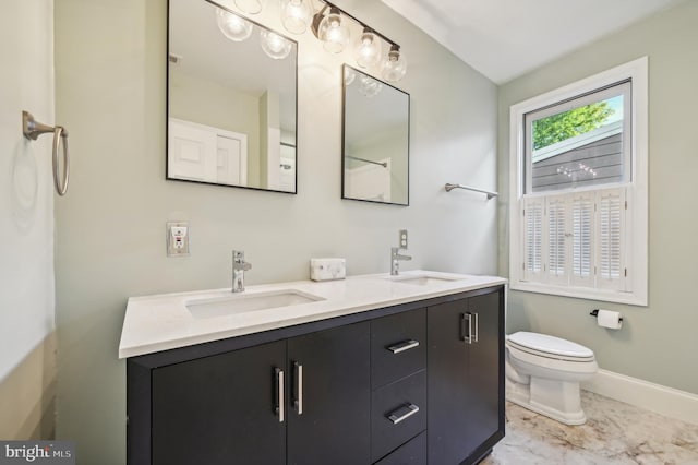 bathroom featuring vanity and toilet