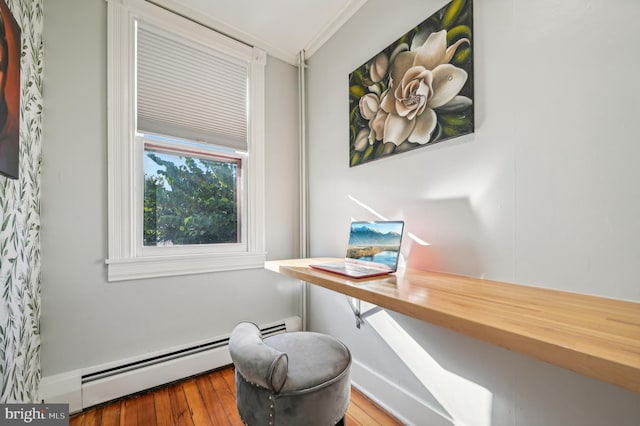 office featuring hardwood / wood-style flooring, crown molding, and a baseboard heating unit