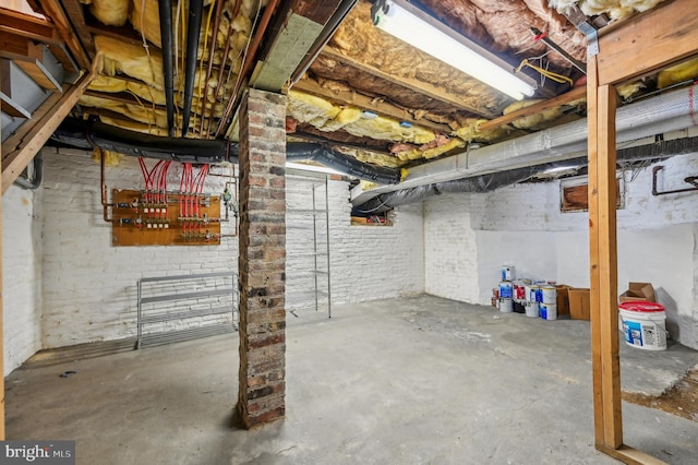 basement featuring brick wall