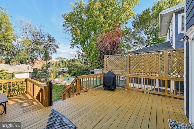 wooden terrace featuring grilling area