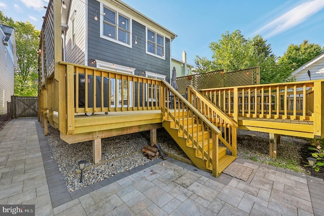 back of house with a deck and a patio area