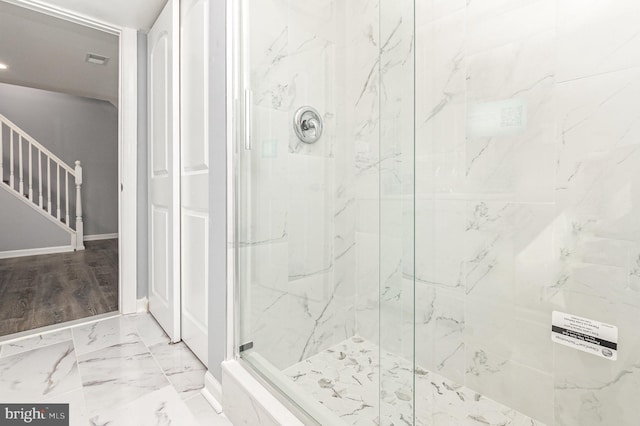 bathroom featuring tiled shower and hardwood / wood-style floors