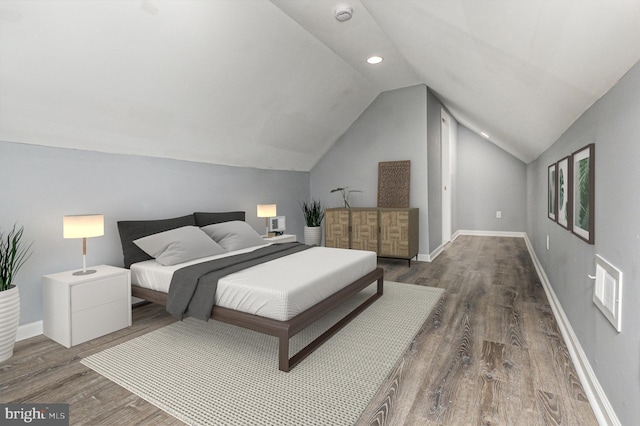 bedroom with dark wood-type flooring and vaulted ceiling