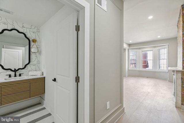 hallway featuring light hardwood / wood-style flooring and sink