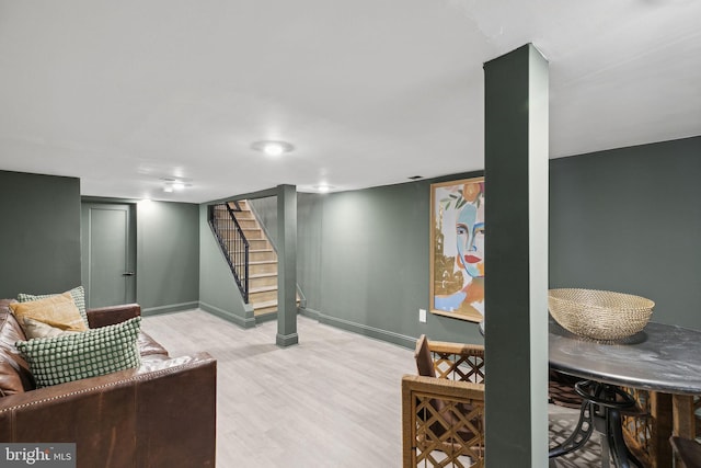 basement with light hardwood / wood-style flooring