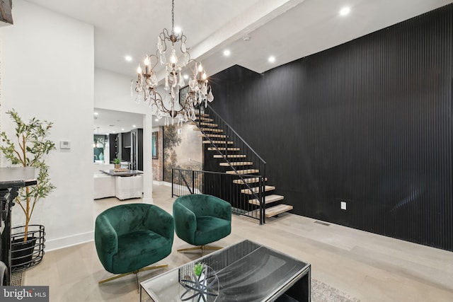 living room with a notable chandelier and light wood-type flooring