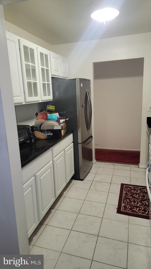 kitchen with white cabinetry and light tile patterned flooring