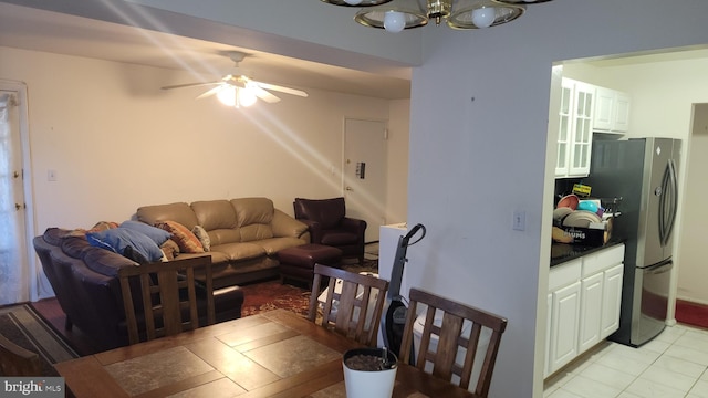 living room featuring ceiling fan with notable chandelier