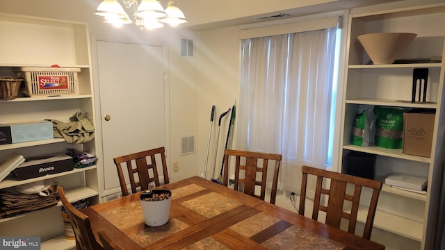 dining space with a notable chandelier