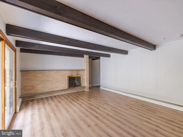 unfurnished living room with wood walls, beamed ceiling, a fireplace, light hardwood / wood-style floors, and baseboard heating