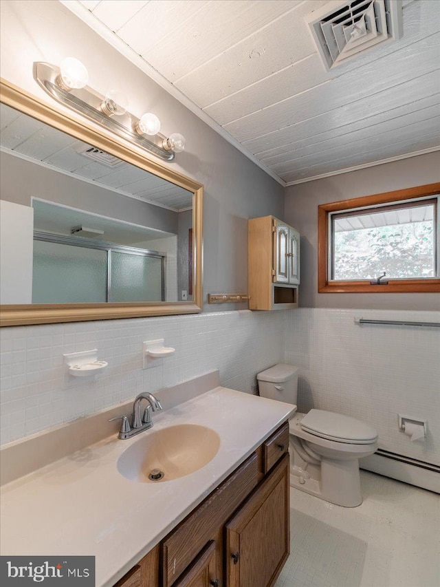 bathroom featuring vanity, toilet, tile walls, and a baseboard heating unit