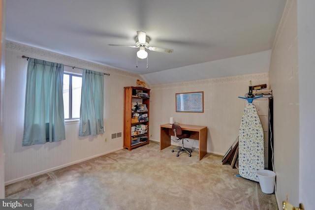 carpeted home office with lofted ceiling and ceiling fan