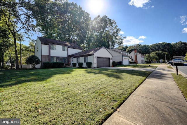 view of front of property with a garage and a front lawn