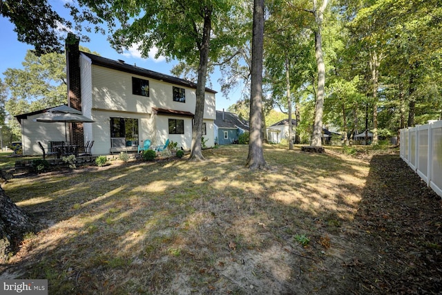 back of house with a lawn