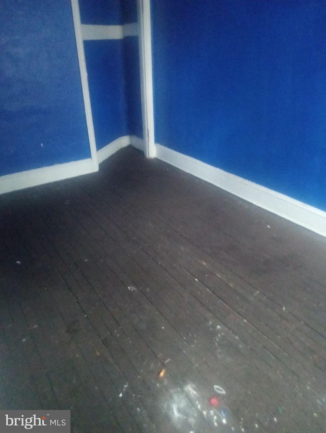 spare room with dark hardwood / wood-style floors