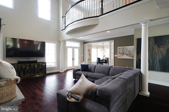 living room featuring a high ceiling, dark wood-type flooring, french doors, and crown molding