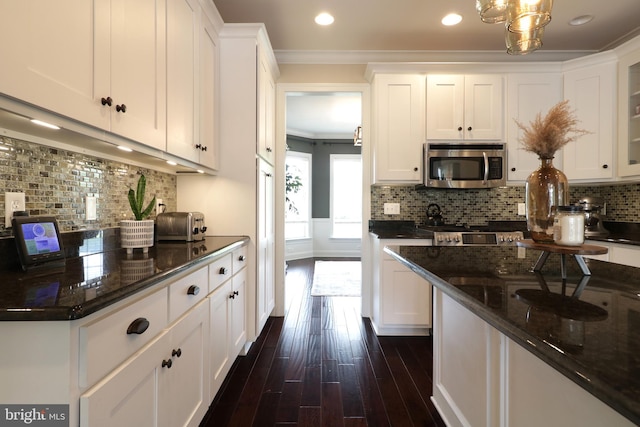 kitchen featuring backsplash, dark stone countertops, white cabinets, and dark wood-type flooring