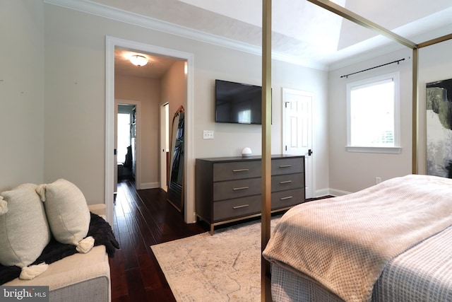 bedroom featuring ornamental molding and dark wood-type flooring