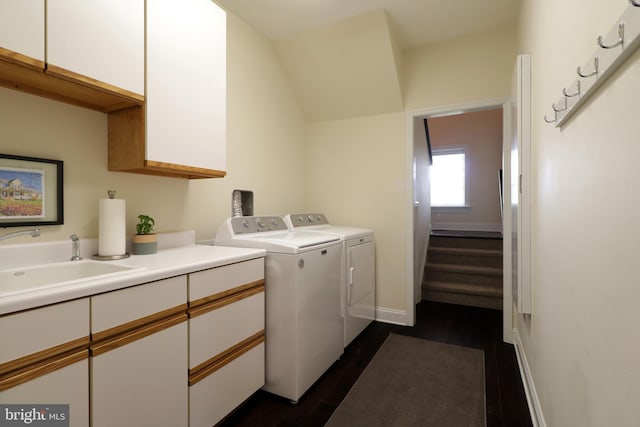 laundry area featuring separate washer and dryer, sink, and dark hardwood / wood-style flooring