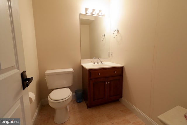 bathroom featuring tile patterned flooring, vanity, and toilet