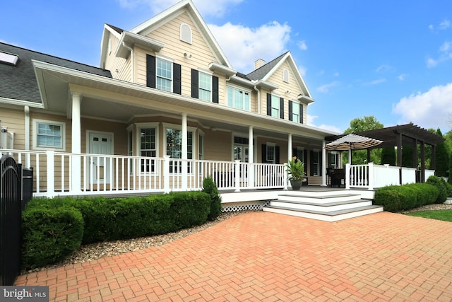 view of front of house with a porch and a pergola