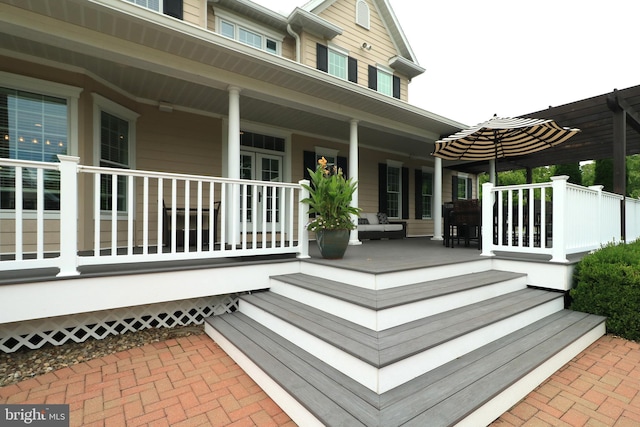 wooden terrace featuring covered porch